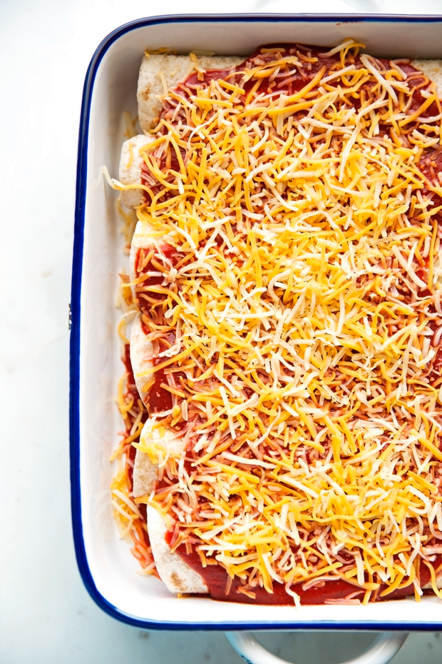 Breakfast enchiladas loaded with shredded potatoes, scrambled eggs, and black beans drizzled with my homemade ranchero sauce and shredded cheese -- comfort food to the max! #breakfast #breakfastenchiladas #enchiladas #rancherosauce | Littlespicejar.com