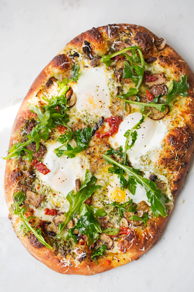 Breakfast Pizza with Basil Pesto and Sun-Dried Tomatoes - a simple breakfast pizza that's topped with fresh eggs and it's so good! #breakfast #breakfastpizza #pizza #pizzanight | Littlespicejar.com
