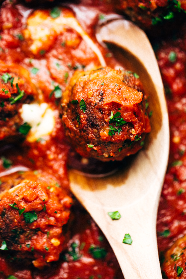 Cheesy Stuffed Meatballs in Homemade Tomato Sauce - The perfect meal for spaghetti and meatball night! Or serve them as party appetizers for New Years, Christmas, and Super Bowl parties! #stuffedmeatballs #cheesestuffedmeatballs #homemadetomatosauce | Littlespicejar.com