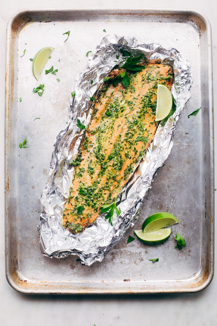 Super Easy Baked Salmon in Foil with Chimichurri Sauce - An easy recipe that takes less than 30 minute to make and is perfect for using on salads or serving with roasted veggies! #bakedsalmon #salmoninfoil #chimichurrisalmon | Littlespicejar.com