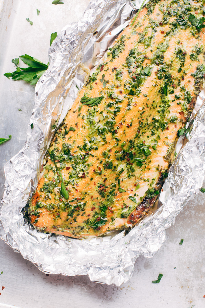 Super Easy Baked Salmon in Foil with Chimichurri Sauce - An easy recipe that takes less than 30 minute to make and is perfect for using on salads or serving with roasted veggies! #bakedsalmon #salmoninfoil #chimichurrisalmon | Littlespicejar.com