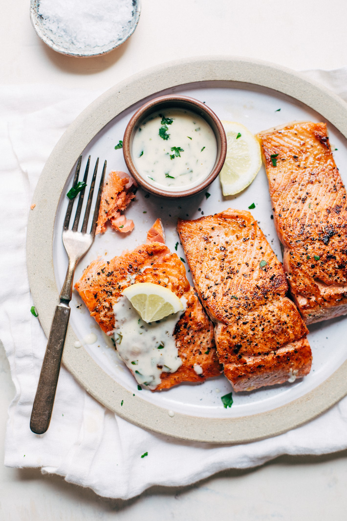 Perfect Pan Seared Salmon with a 4 Ingredient Lemon Butter Cream Sauce! This sauce is DYNAMITE or just about any kind of seafood! #pansearedsalmon #lowcarb #highprotein #salmon #lemonbuttersauce | Littlespicejar.com