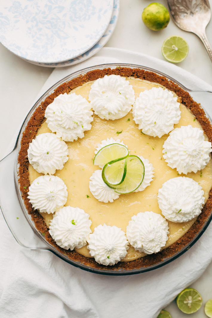 Summertime Key Lime Pie - A completely homemade sweet and tart key lime pie with the most delicious graham cracker crust! This pie is perfect to take to all your summer gatherings! #keylimepie #grahamcrackercrust #pie #4thofjuly | Littlespicejar.com
