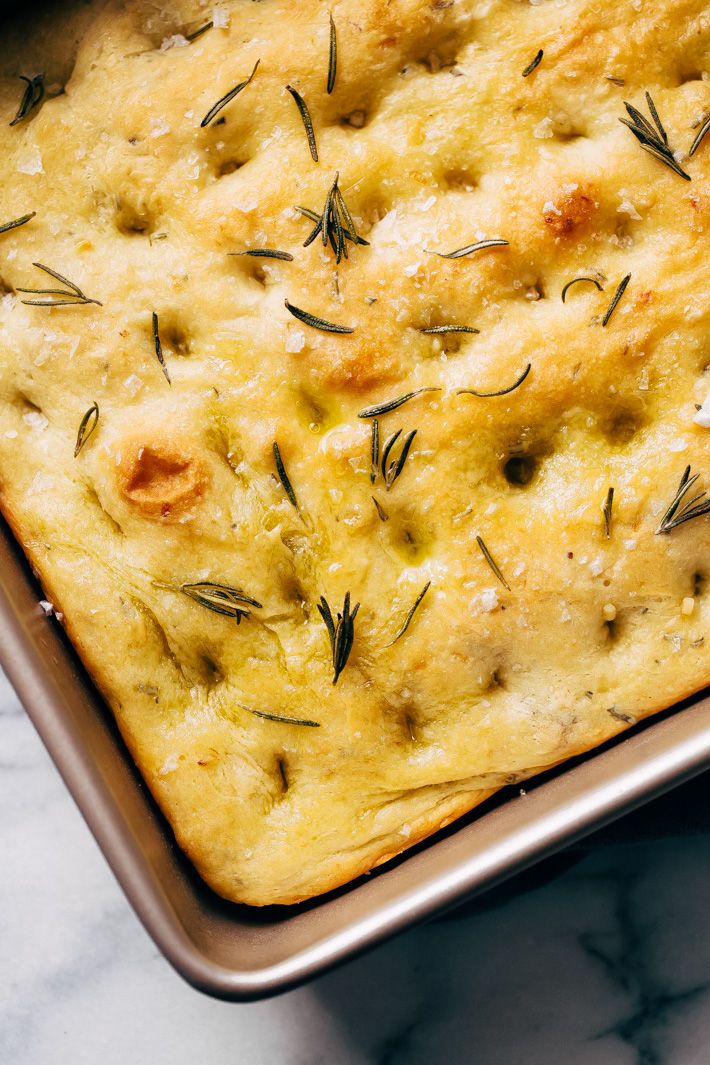 Roasted Garlic Rosemary Focaccia Bread - learn how to make this delicious bread. Serve it with soup, as a side of pasta, or build a sandwich with it! Rosemary focaccia is easy to make and absolutely delicious! #focacciabread #focaccia #rosemaryfocaccia #bread | Littlespicejar.com