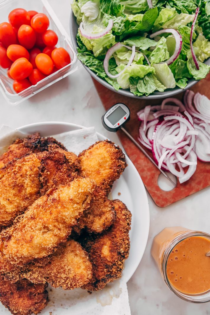 Crispy Chicken Salad with Sriracha Honey BBQ Dressing - homemade crispy chicken tenders tossed with all your favorite salad toppings and drizzled with homemade sriracha honey bbq dressing! So good it's sure to become a family favorite! #crispychickensalad #chickfilasauce #honeybbqchickensalad #salad | Littlespicejar.com