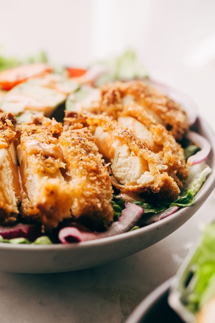 Crispy Chicken Salad with Sriracha Honey BBQ Dressing - homemade crispy chicken tenders tossed with all your favorite salad toppings and drizzled with homemade sriracha honey bbq dressing! So good it's sure to become a family favorite! #crispychickensalad #chickfilasauce #honeybbqchickensalad #salad | Littlespicejar.com