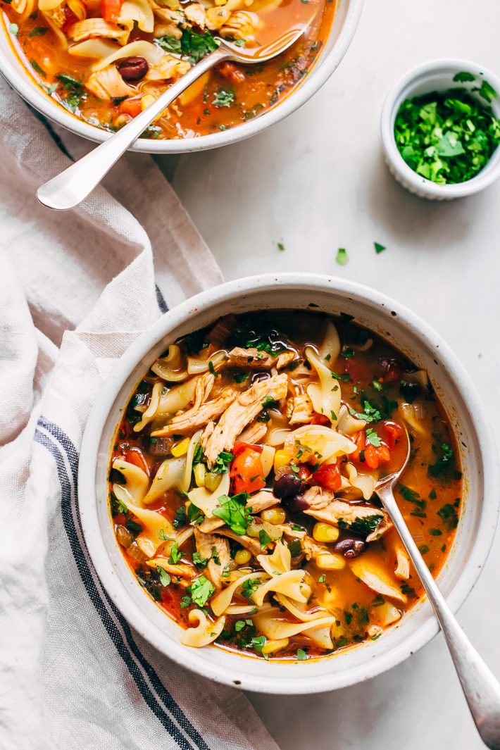 Mexican Chicken Noodle Soup - loaded with tender chicken, corn, beans, and of course, noodles! Ready in under 30 minutes! #chickennoodlesoup #southwesternchickennoodlesoup #soup #souprecipes | Littlespicejar.com