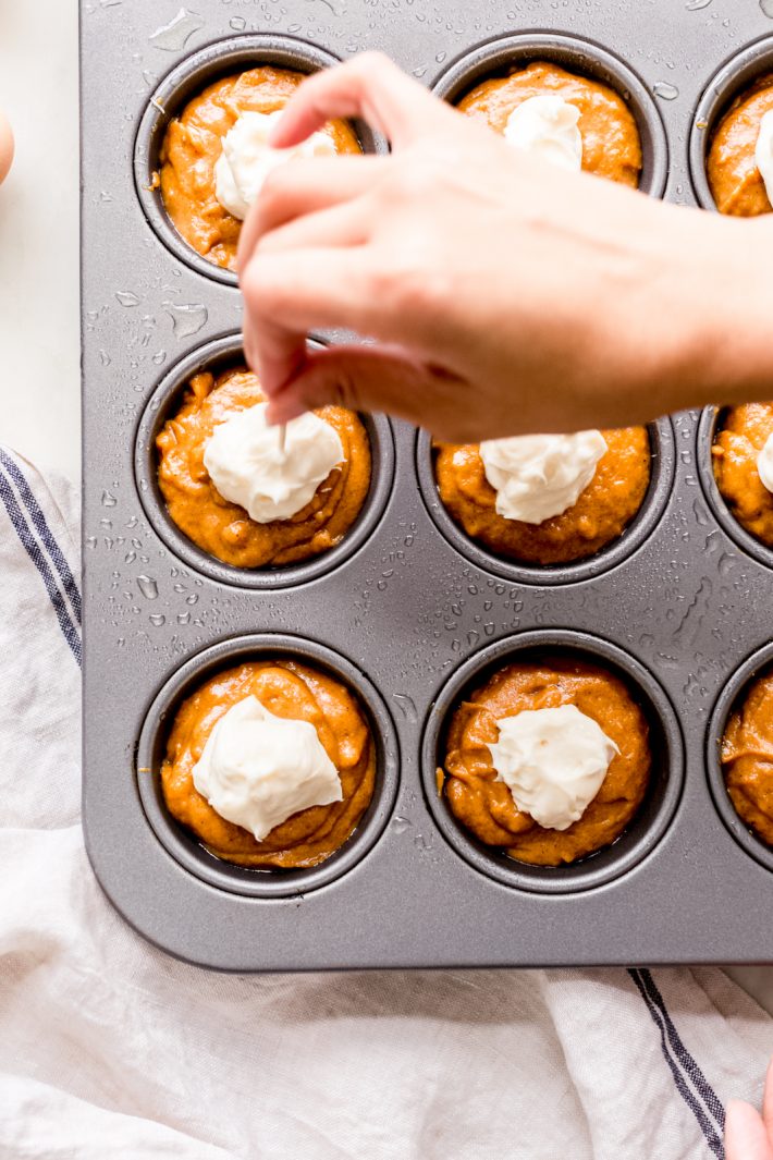 Spiced Chai Pumpkin Cheesecake Muffins - these are pumpkin muffins stuffed and topped with cheesecake batter! They're the perfect balance of sweet so they're perfect with a warm cup of coffee in the morning! #pumpkinmuffins #chai #pumpkincheesecakemuffins #spicedpumpkinmuffins #baking | Littlespicejar.com