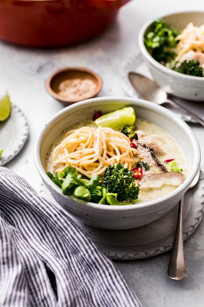 Thai Green Curry Chicken Soup - Learn how to make a 20 minute chicken curry soup that'll please the whole family! Tons of noodles, tender chicken, and creamy green curry soup! #thaigreencurry #greencurrysoup #greencurrychickensoup #chickensoup #chickencurrysoup #soup #comfortfood | Littlespicejar.com