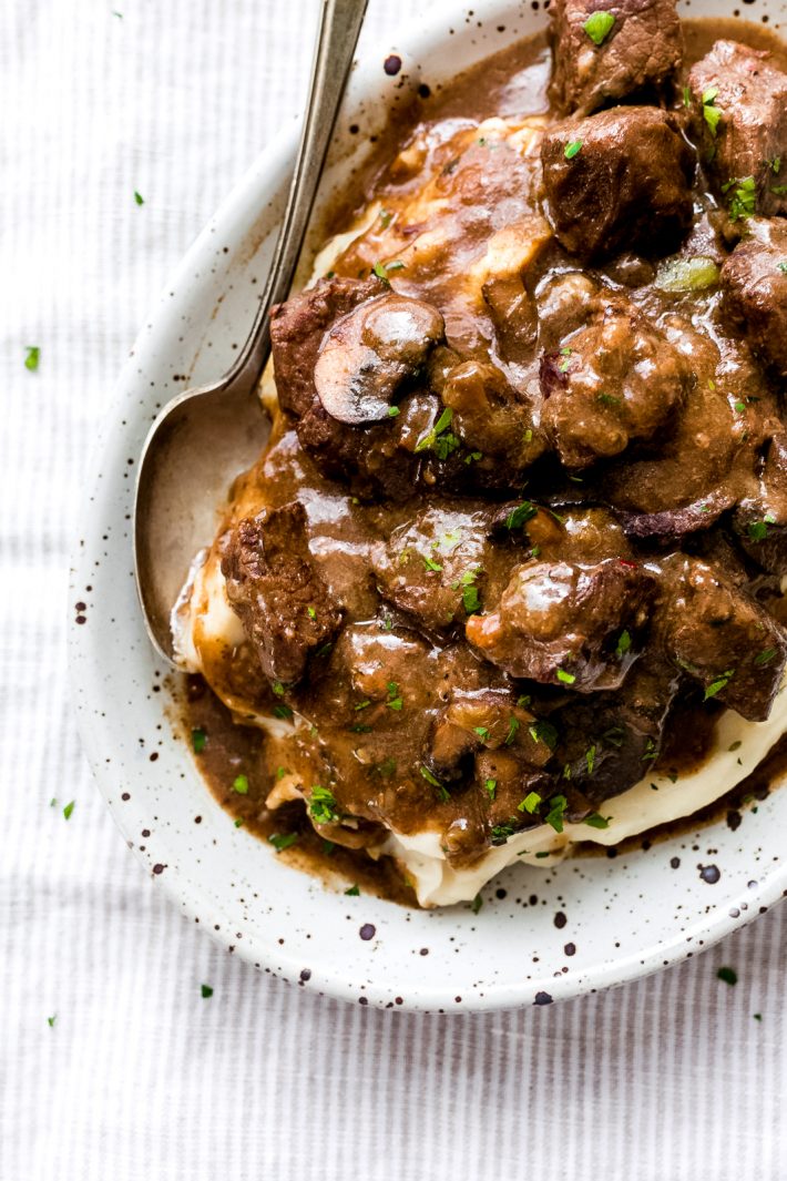 Ridiculously Tender Beef Tips with Mushroom Gravy - Easy beef tips in mushroom gravy that you can make in the instant pot or the slow cooker! This recipe is sure to be a hit with your entire family! #beeftips #beeftipsandmushroomgravy #beefstew #instanpotrecipe #instantpot #slowcooker #slowcookerbeeftips | Littlespicejar.com