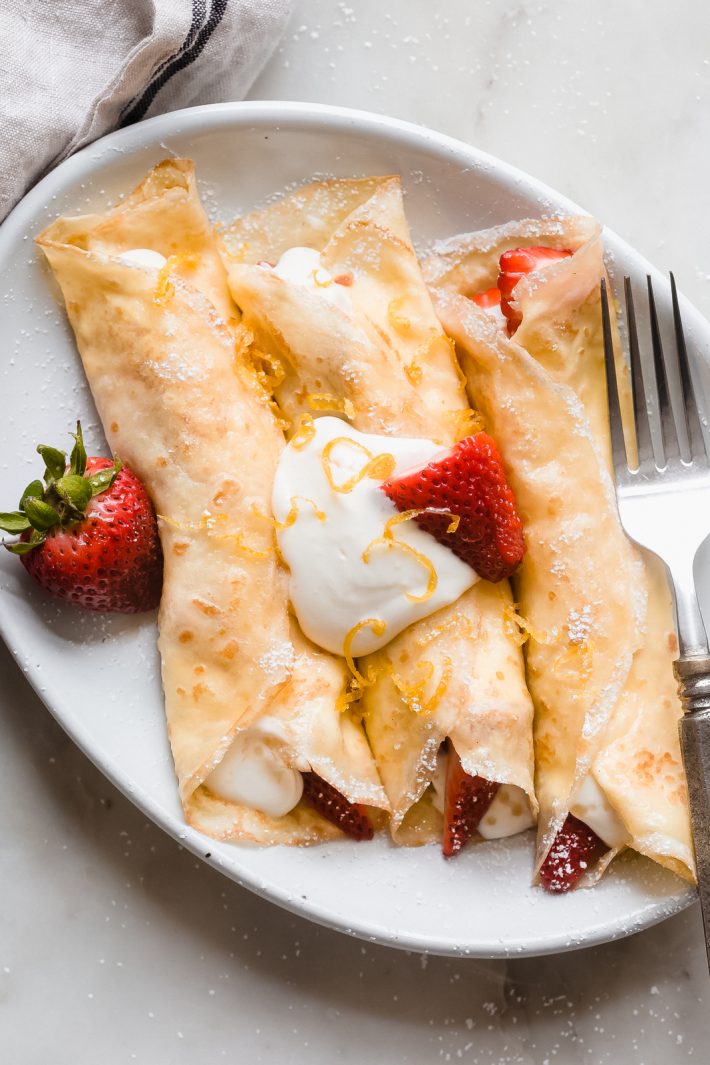 Easy Blender Crepes - Learn how to make crepe batter in the blender! You can make them savory or sweet! Stuff with ice cream, berries, whipped cream, or savory fillings! #crepes #easycrepes #blendercrepes #brunch #mothersday #brunchrecipes | Littlespicejar.com