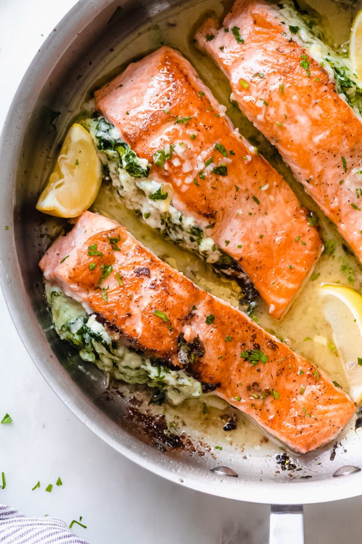 Creamy Spinach Artichoke Stuffed Salmon with Lemon Butter Sauce - An easy yet fancy dinner that's quick enough to prepare for weeknights and fancy enough to serve company! The lemon butter sauce is truly to-die-for! #stuffedsalmon #searedsalmon #salmonrecipes #ketorecipes #keto #ketodinner #salmonrecipes | Littlespicejar.com