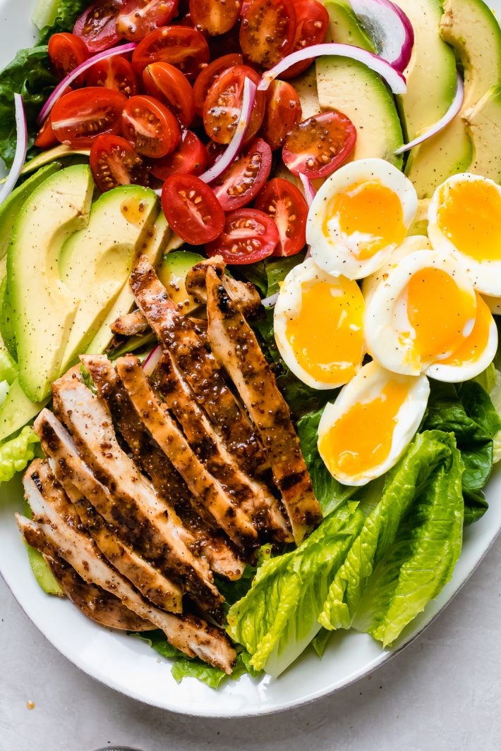 Honey Mustard Chicken Cobb Salad - An easy cobb salad where the dressing doubles as a marinade for the chicken. Served with soft boiled eggs, cherry tomatoes, and sliced avocados #chickensalad #chickencobbsalad #chicken #salad #cobbsalad | Littlespicejar.com