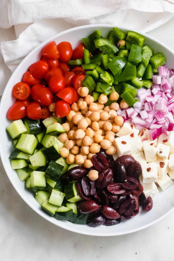 ingredients for greek salad in a white bowl 
