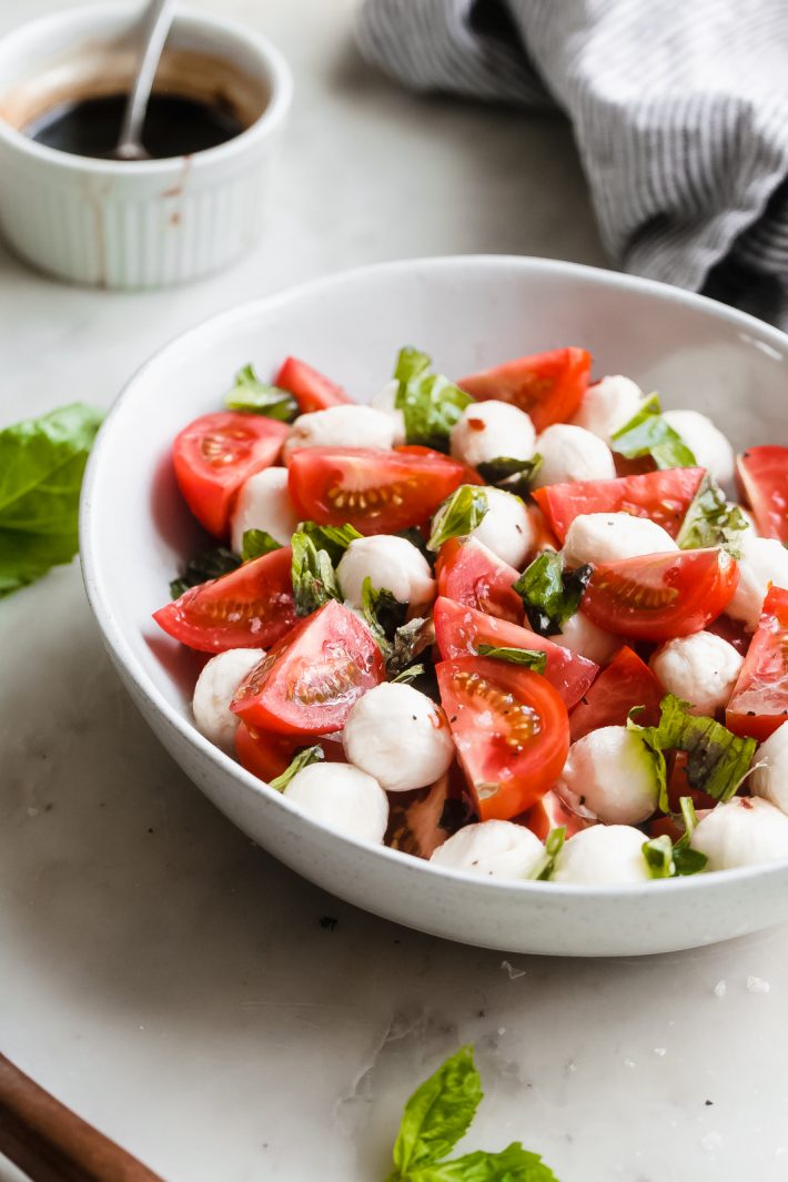 Marinated Mozzarella Tomato Salad - an easy salad that is loaded with marinated mozzarella, fresh tomatoes, basil. This is the PERFECT SUMMER SALAD RECIPE! #summer #mozzarellasalad #tomatosalad #tomatobasilsalad #capresesalad #saladrecipes | Littlespicejar.com