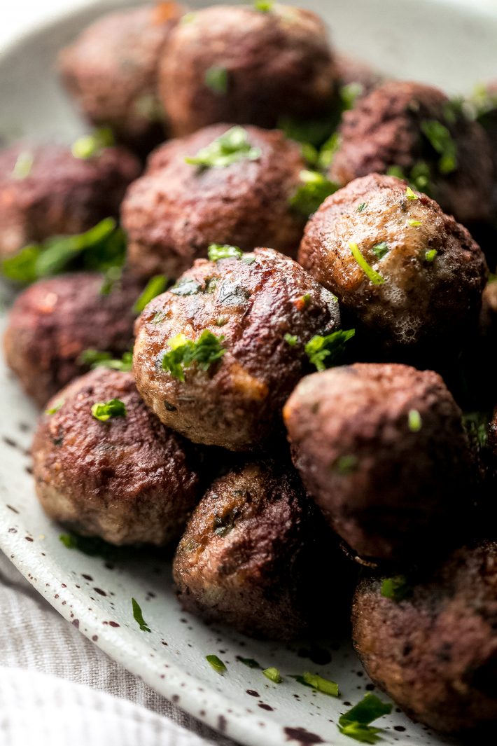 Greek Meatballs (Keftedes) - Learn how to make Greek Meatballs or Keftedes. These meatballs are scented with spices, loaded with grated onions and garlic and fresh parsley, so they’re flavorful and perfect to stuff inside pitas and top with tzatziki! #keftedes #greekmeatballs #meatballs #pitawraps #mezzeplatter | Littlespicejar.com