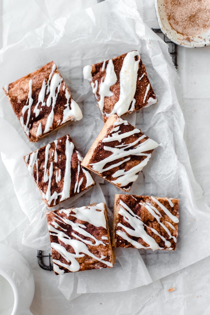 Cinnamon roll blondies are so addicting! It’s a chewy blondie base, swirled with cinnamon sugar and topped with a tangy cream cheese icing -- just the way a good cinnamon roll should be!  #blondies #cinnamonrolls #cinnamonrollblondies #dessert #thanksgiving #christmas | Lilttlespicejar.com