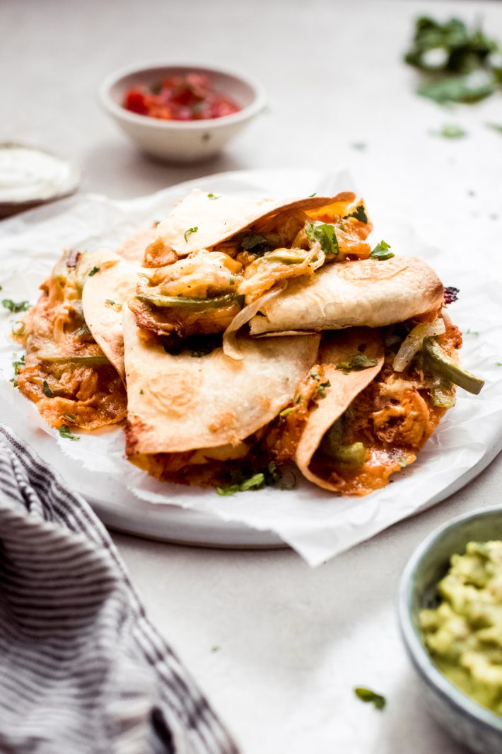 Crispy Baked Chicken Quesadillas - loaded with peppers, onions, creamy chicken and baked until they're crispy and melty! #bakedquesadillas #chickenquesadillas #quesadillas #bakedchickenquesadillas #cincodemayorecipes #superbowlrecipes | Littlespicejar.com