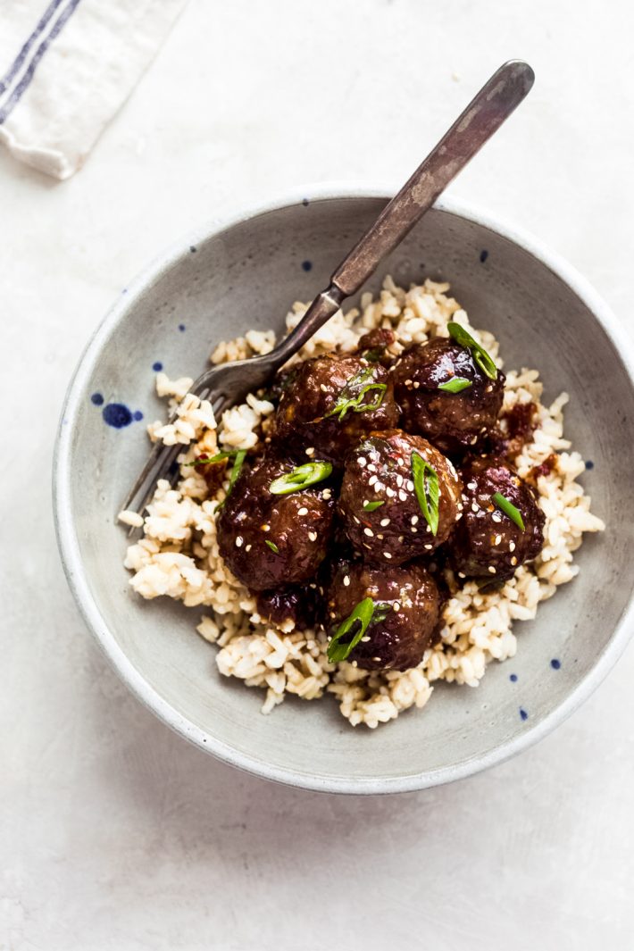Sticky Mongolian Beef Meatballs - Turn your favorite Asian take out into meatballs! These meatballs are made with ground beef and are tender to the core. Toss them in a sweet, savory, and sticky glaze and watch the crowd gobble them up for game day! #footballfood #superbowlrecipes #meatballs #beefmeatballs #appetizers | Littlespicejar.com