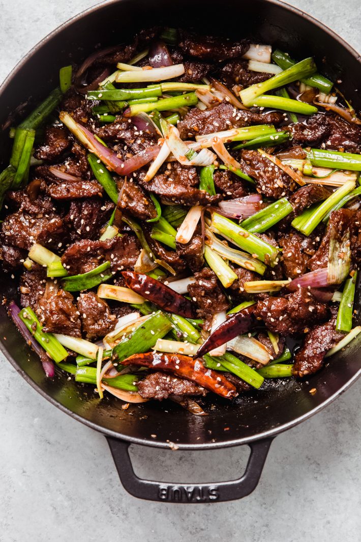 dutch oven with sautéed beef with onions and scallions