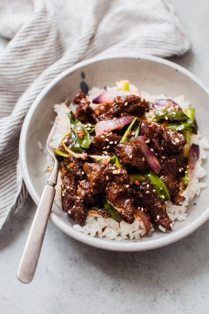 white rice with sautéed Mongolian Beef on top with a fork