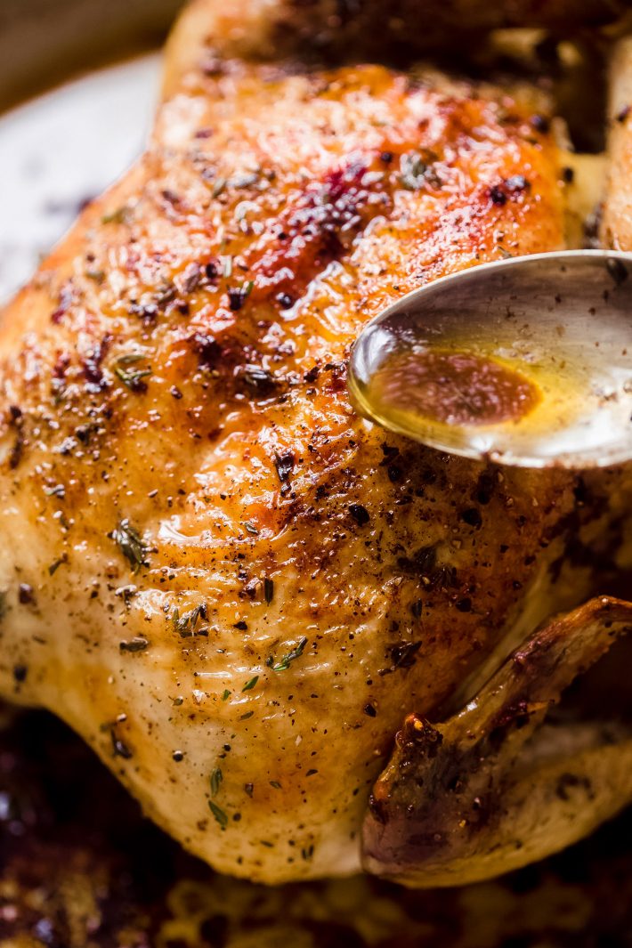spooning butter over roasted chicken