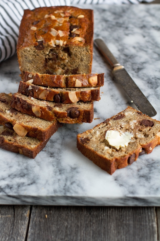 Coconut Chocolate Chip Banana Bread - Made with coconut oil, greek yogurt, and whole wheat flour. This bread is to DIE for! #bananabread #chocolatechip #bananamuffins | Littlespicejar.com