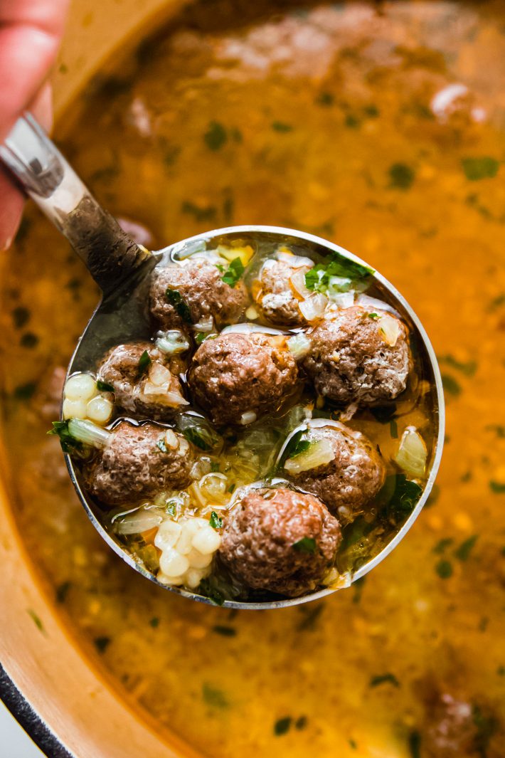 ladle with meatballs and couscous