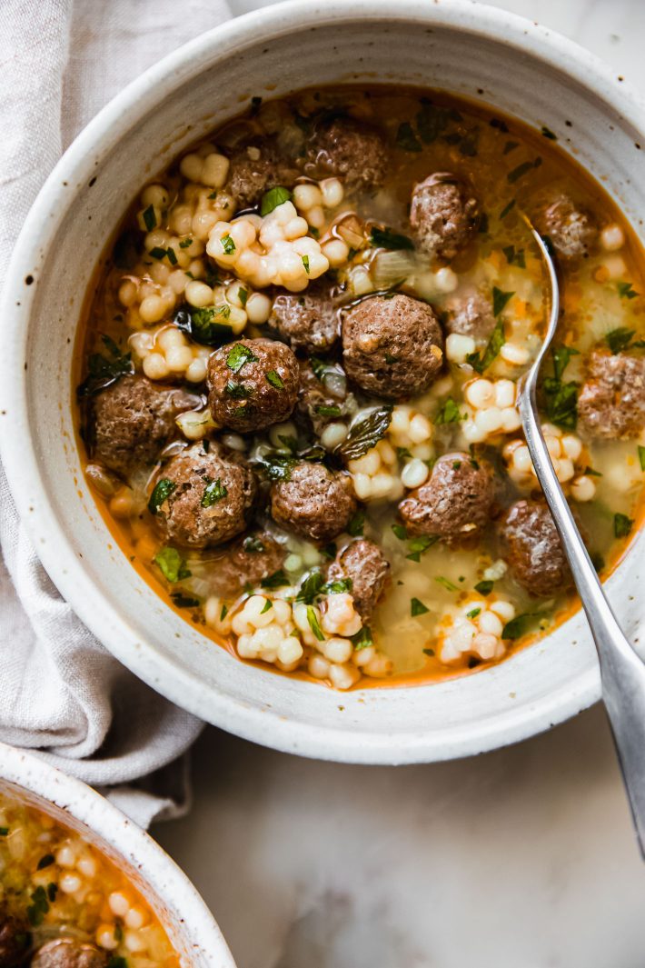 spoon in speckled bowl with meatball soup