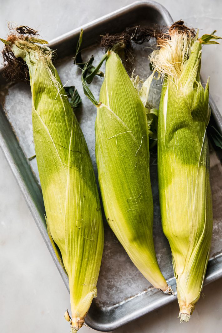 corn on sheet pan with husk