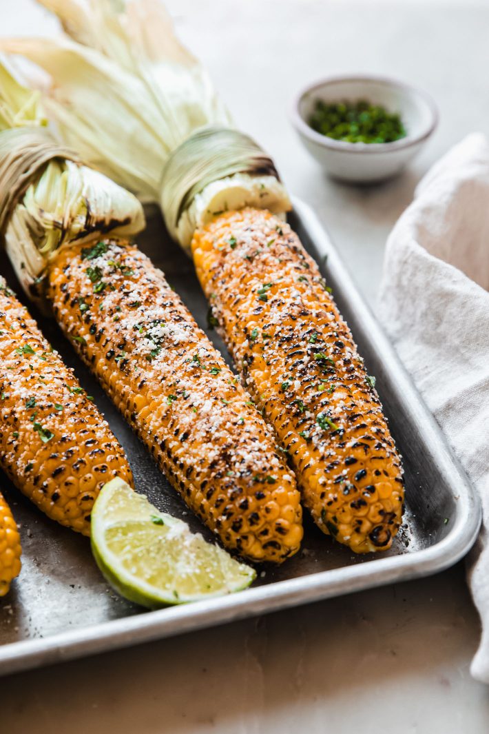 Mexican street corn topped with cotija, cilantro, and mayo