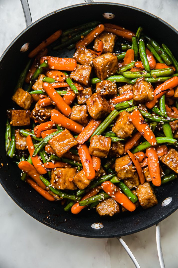 Tofu stir fry with carrots and green beans in pan