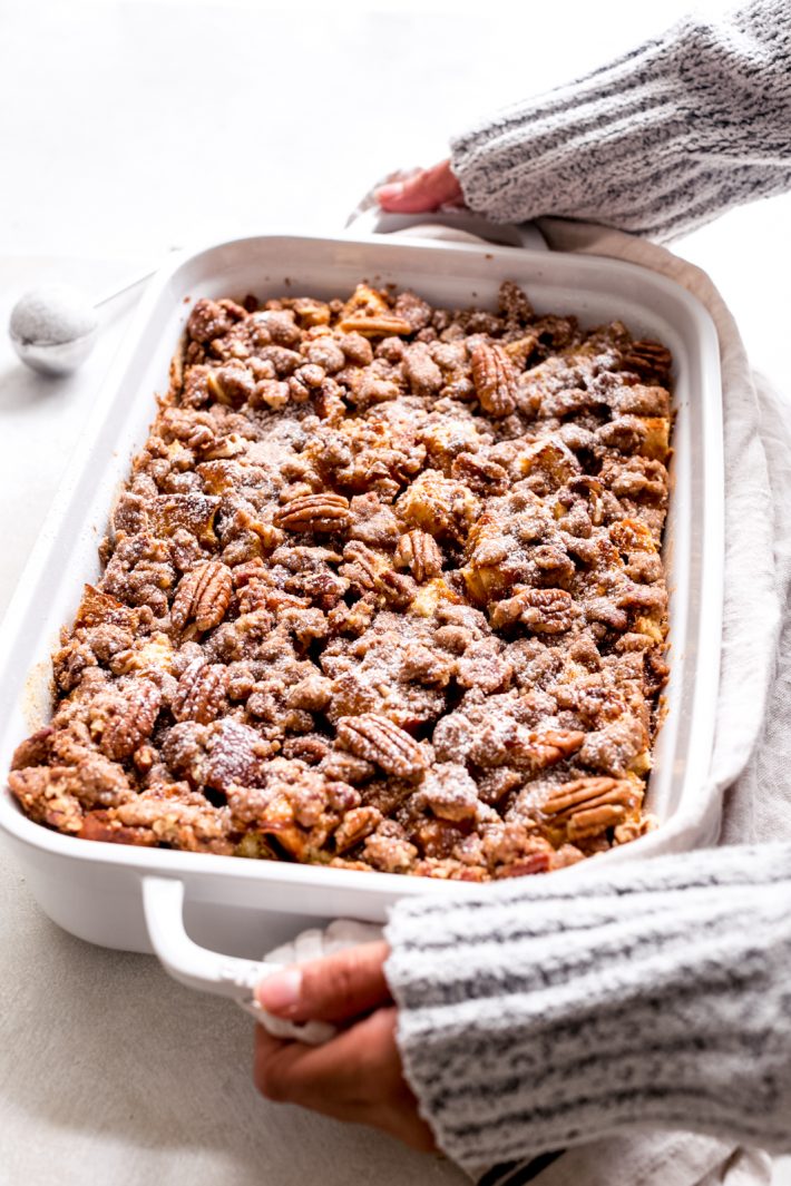 baking dish with pumpkin French toast casserole held by handles
