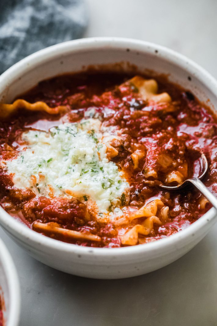 lasagna soup in bowl topped with ricotta mixture