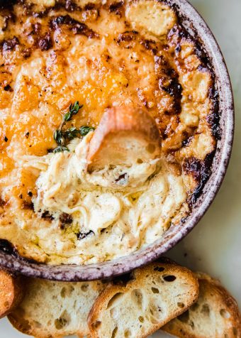 hot caramelized onion dip on marble with crostini
