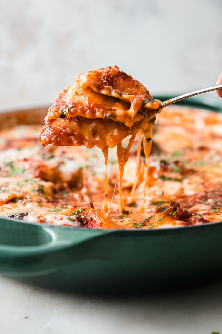 fork raising ravioli lasagna from skillet