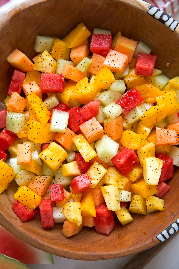 Mexican Fruit Salad - a fruit salad that combines watermelon, cantaloupe, honey dew, and mangoes that are tossed in a sweet spicy dressing! Perfect for summer! #mexicanfruit #fruitsalad #salad #mexicanfruitsalad | Littlespicejar.com