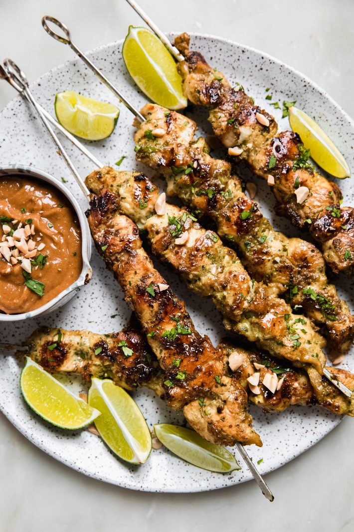 satay sauce in bowl with chicken skewers