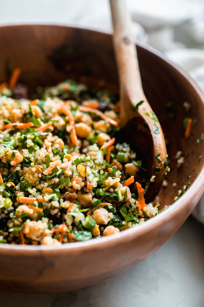 bowl of quinoa salad showing carrots, pistachios, chickpeas and parsley