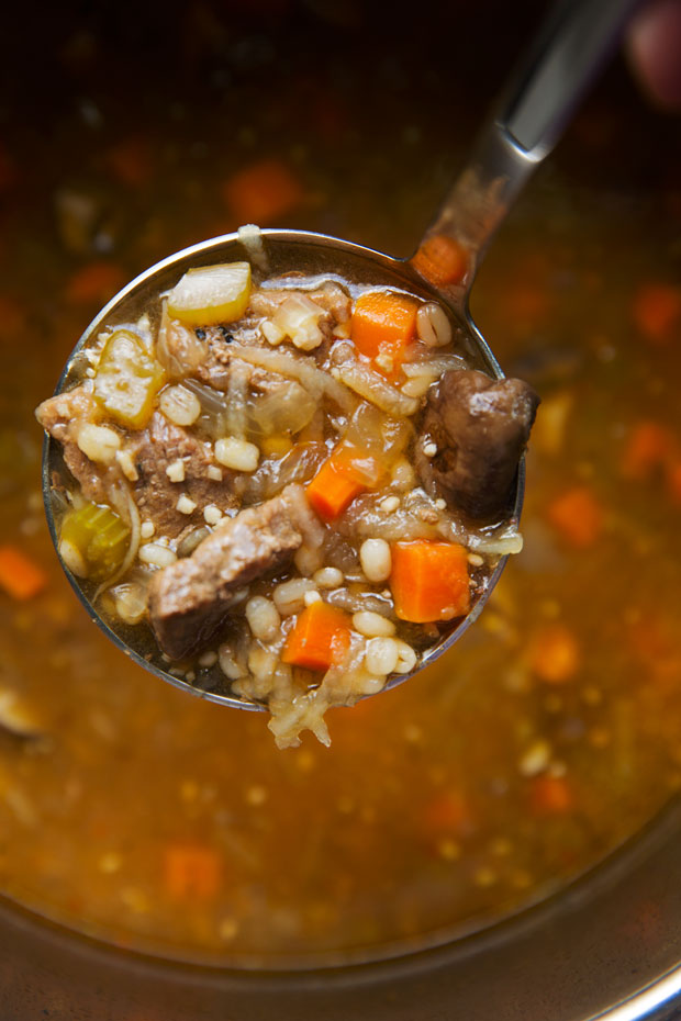 close up of ladleful of soup
