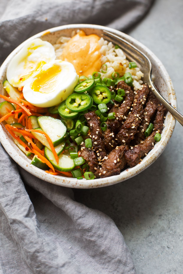 Korean BBQ Bowls with Garlic Scented Rice - Warm, comforting bowls with marinated steak, garlic rice, and a pickled cucumber salad. It's seriously amazing! #koreanbbqbowls #bowls #garlicrice | Littlespicejar.com