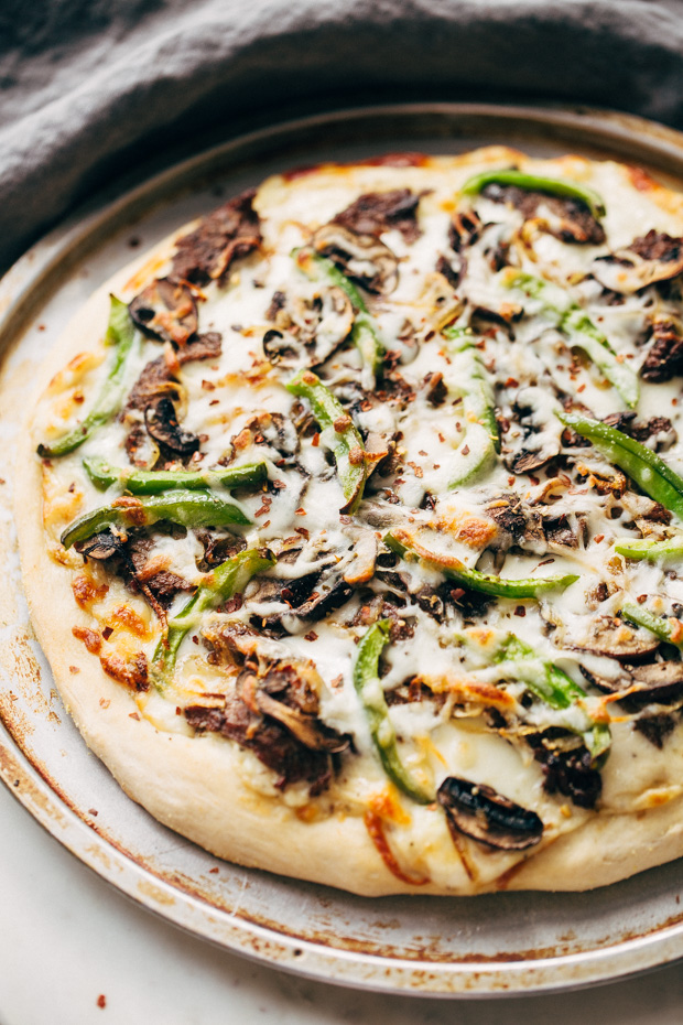 Philly Cheese Steak Pizza - Change up your Friday night pizza routine with a homemade Philly cheese steak pizza! Loaded with tons of veggies and meat, it's sure to be a crowd-pleaser! #pizza #phillycheesesteakpizza #steakpizza | Littlespicejar.com