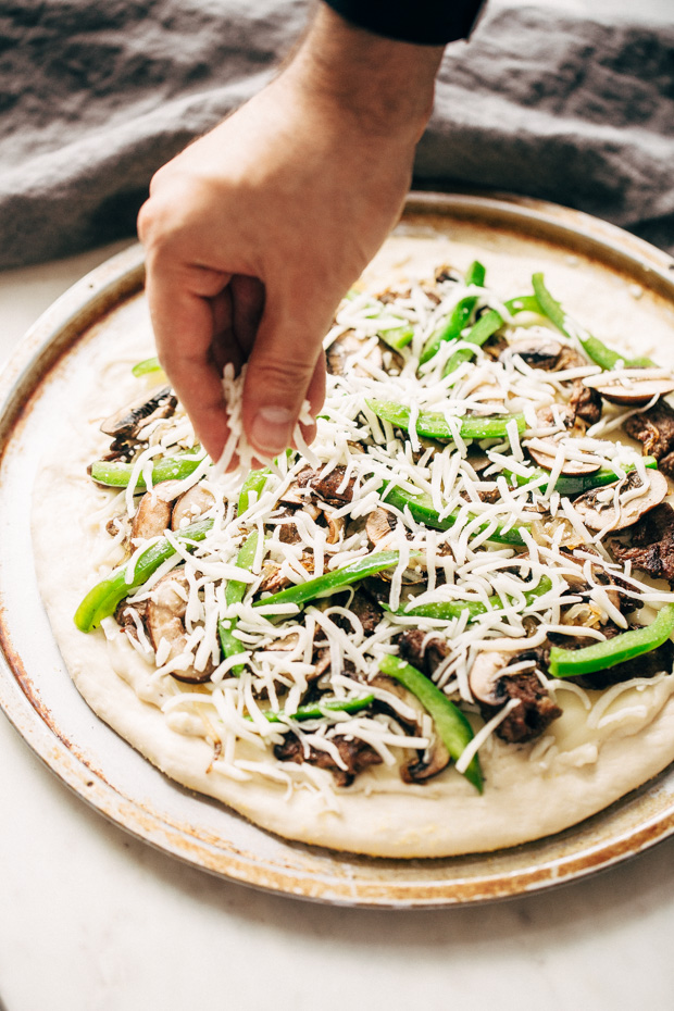 Philly Cheese Steak Pizza - Change up your Friday night pizza routine with a homemade Philly cheese steak pizza! Loaded with tons of veggies and meat, it's sure to be a crowd-pleaser! #pizza #phillycheesesteakpizza #steakpizza | Littlespicejar.com