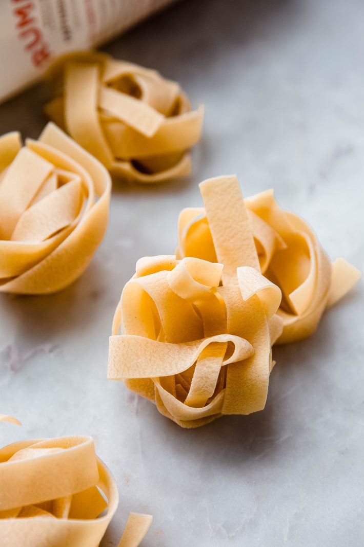 pappardelle nests on white marble