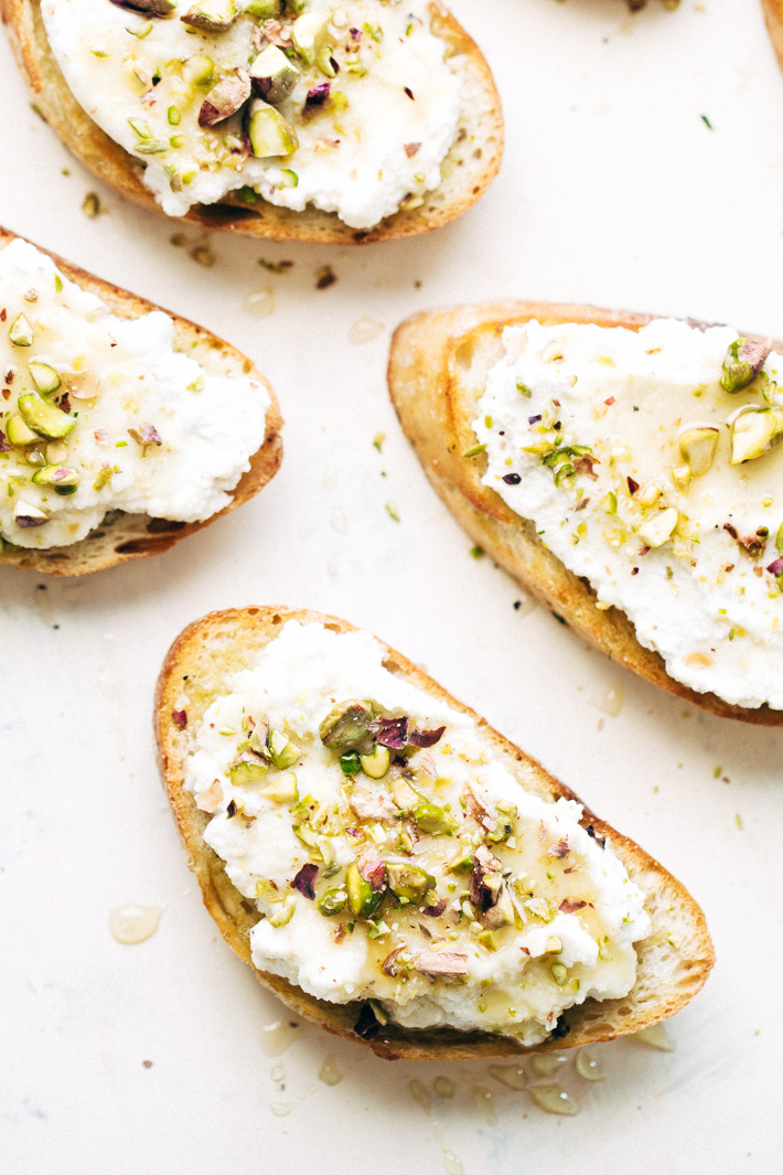 Ricotta Toasts with Pistachios and Honey - A quick and easy appetizer. The bread is warm, the ricotta is creamy, with a kiss of chopped pistachios and a drizzle of honey! #appetizers #toasts #ricottatoasts | Littlespicejar.com