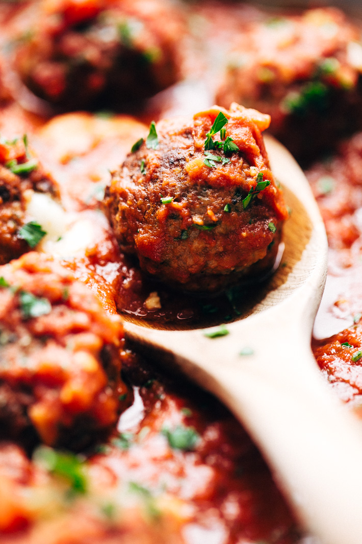 Cheesy Stuffed Meatballs in Homemade Tomato Sauce - The perfect meal for spaghetti and meatball night! Or serve them as party appetizers for New Years, Christmas, and Super Bowl parties! #stuffedmeatballs #cheesestuffedmeatballs #homemadetomatosauce | Littlespicejar.com