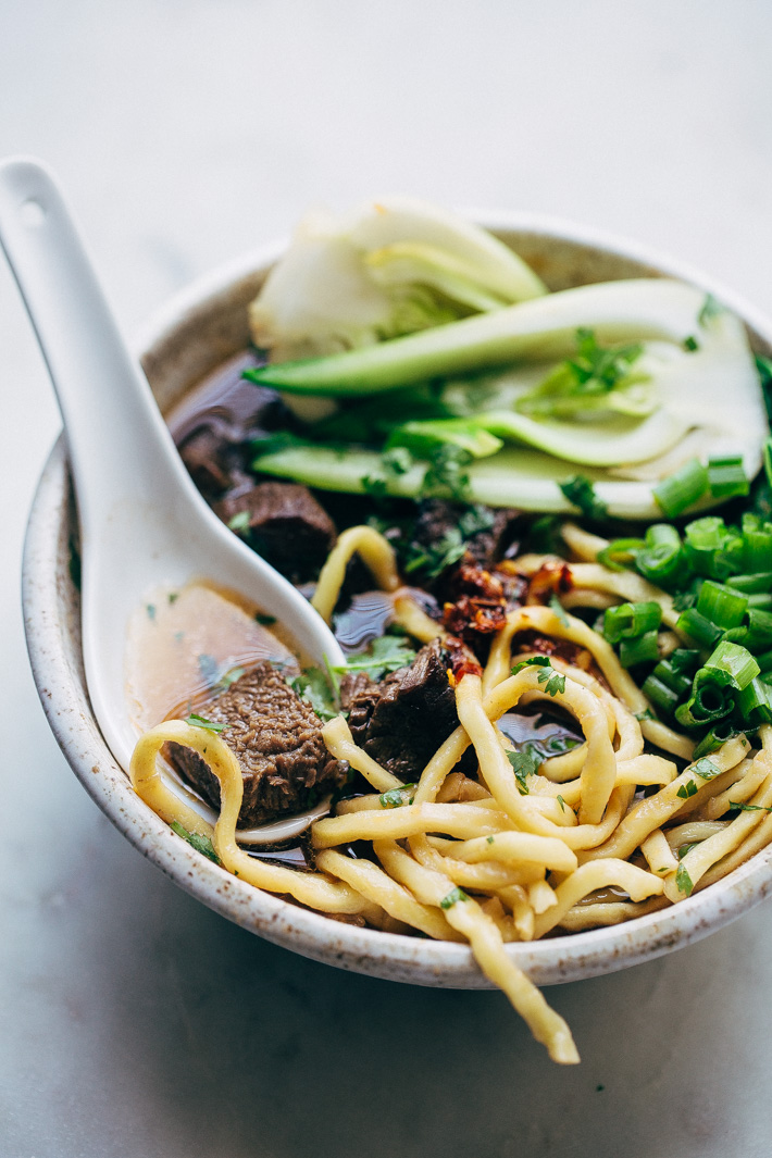 Comfy Cozy Taiwanese Beef Noodle Soup - thick and chewy noodles in a homemade. slow simmered broth with tons of tender beef and fresh greens! #beefnoodlesoup #beefsoup #taiwanesebeefnoodlesoup #asiannoodlesoup | Littlespicejar.com