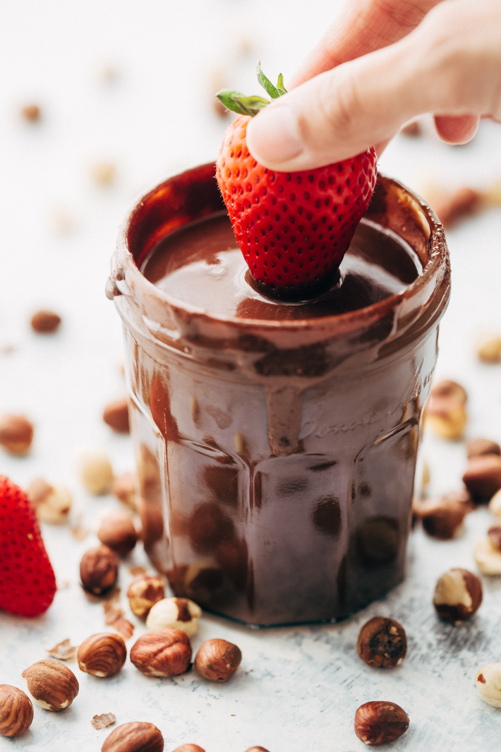 strawberry dipping in chocolate hazelnut spread