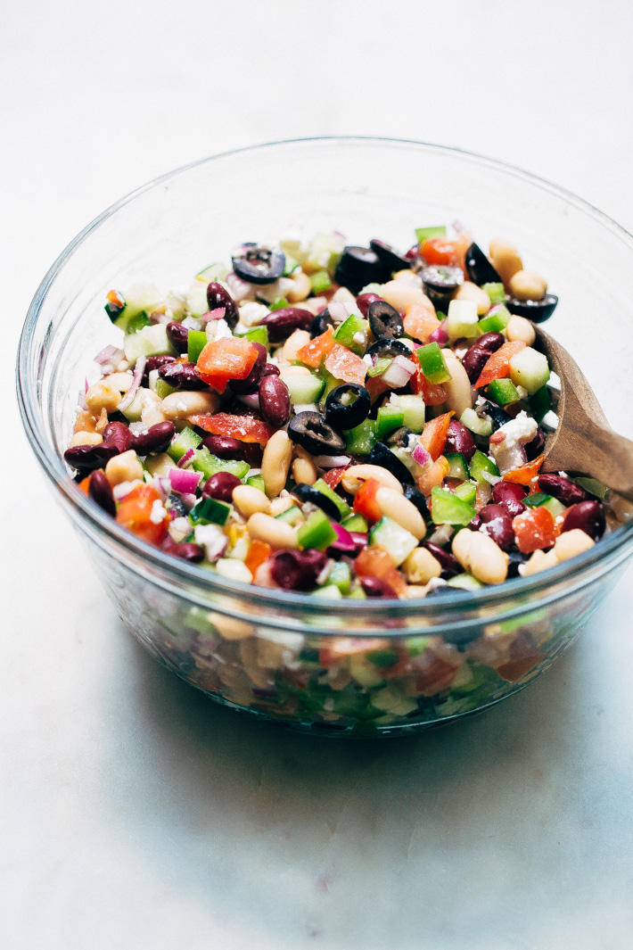 Veggie-Packed Three Bean Greek Salad - A three bean salad meets a chopped greek salad. This salad takes 15 minutes to make and is a nice change to the usual ones we enjoy in the summer! #threebeansalad #choppedgreeksalad #greeksalad #3beansalad #salad | Littlespicejar.com
