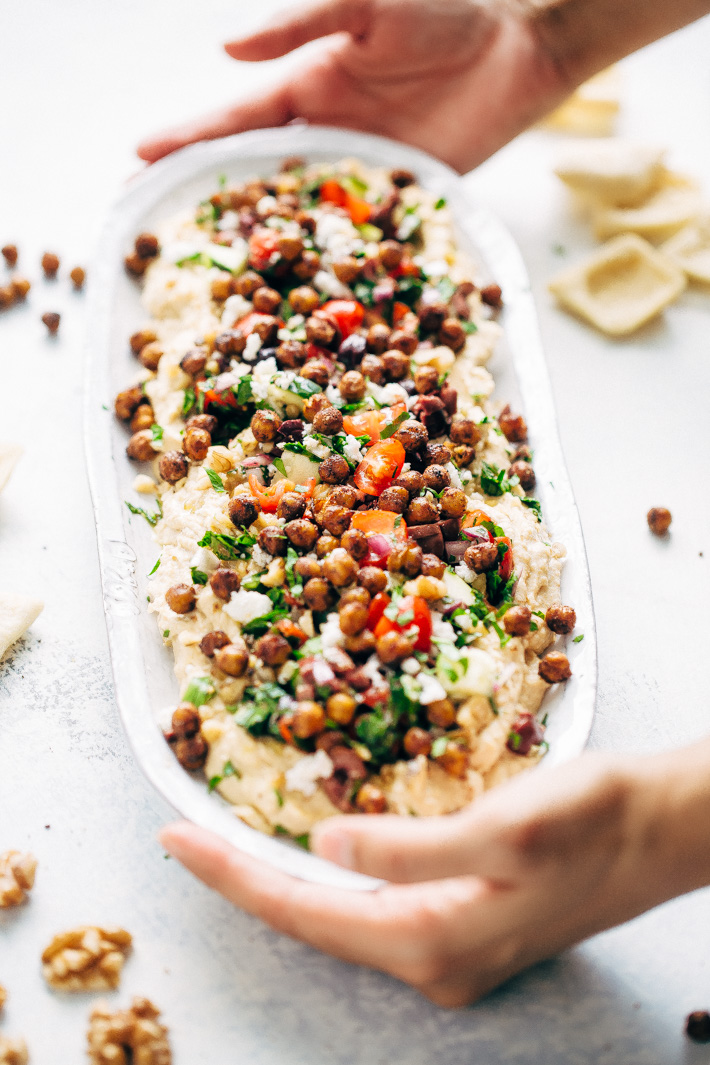 Seven Layer Chickpea Shawarma Dip - Smooth hummus topped with a parsley salad, salty feta, crunchy roasted chickpeas, and so much more! #7layerdip #sevenlayerdip #shawarma #shawarmadip #roastedchickpeas #sponsored by @californiawalnuts | Litttlespicejar.com
